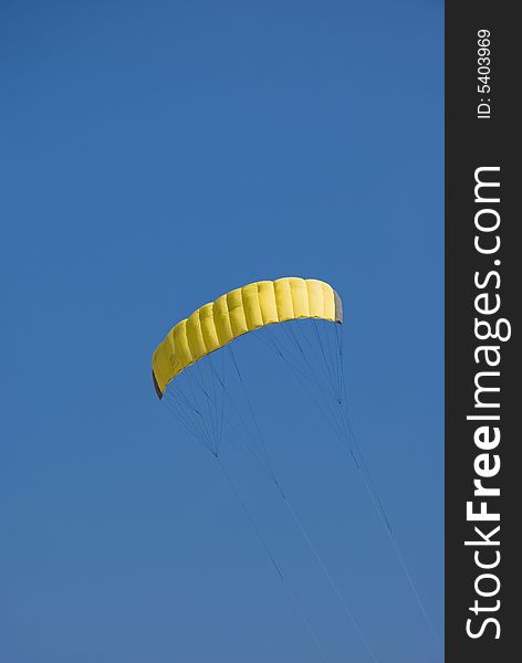 Yellow kite in the blue sky