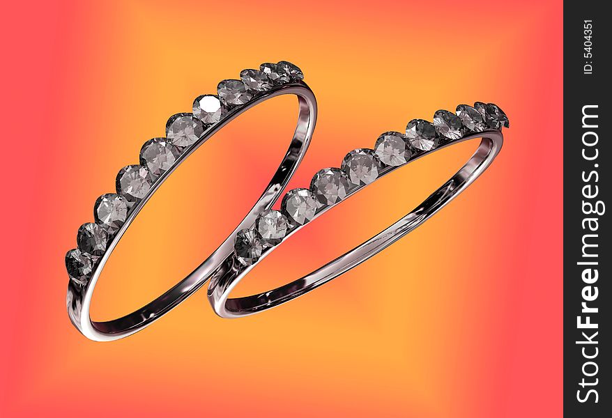 Two rings with diamonds against a colorful background