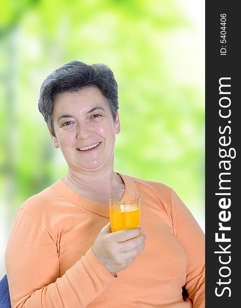 Mature woman holding glass of juice
