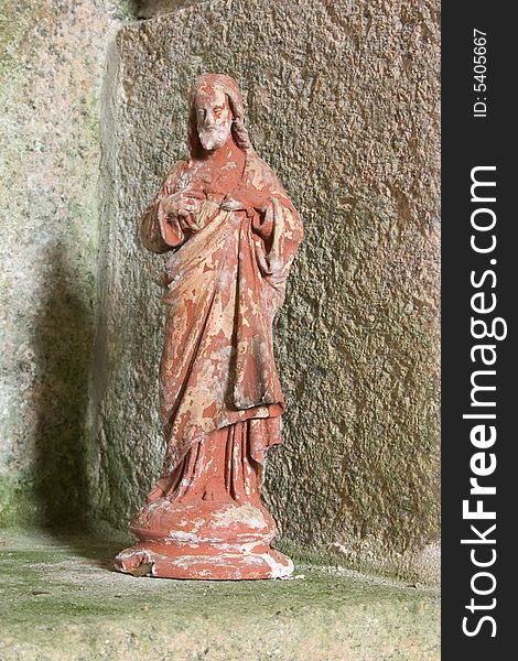 An old plaster statue of jesus christ in an old catholic church in france. An old plaster statue of jesus christ in an old catholic church in france