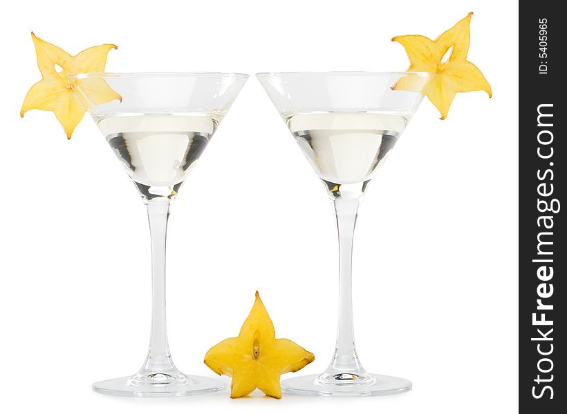 Glass of martini and slice of carambola on a white background. Glass of martini and slice of carambola on a white background