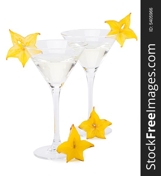 Glass of martini and slice of carambola on a white background. Glass of martini and slice of carambola on a white background