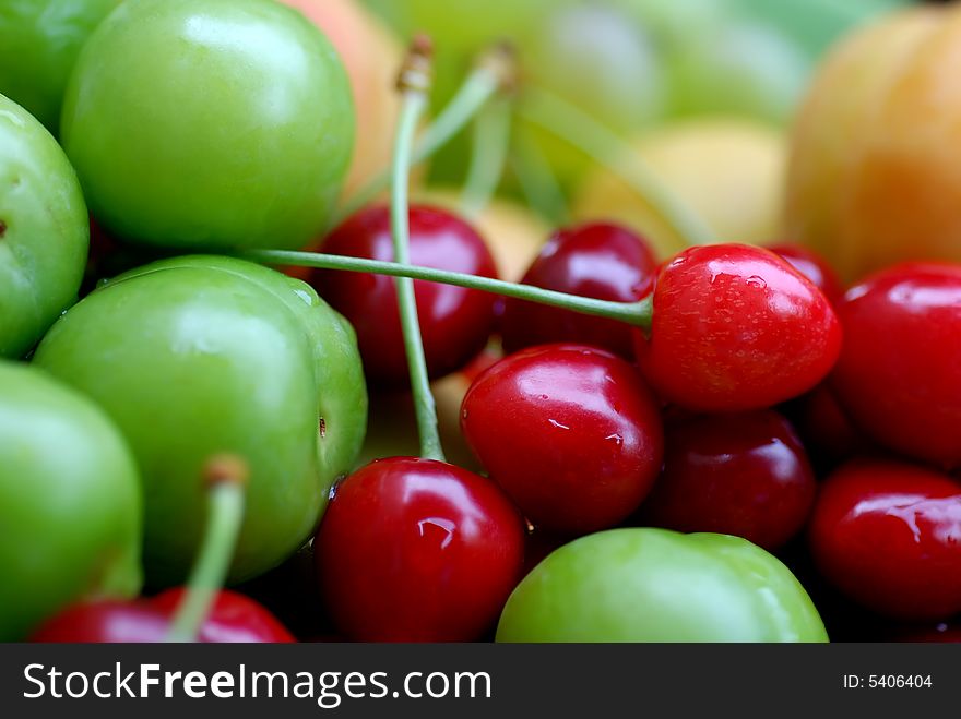 Close up to delicious fresh sour cherries and plums