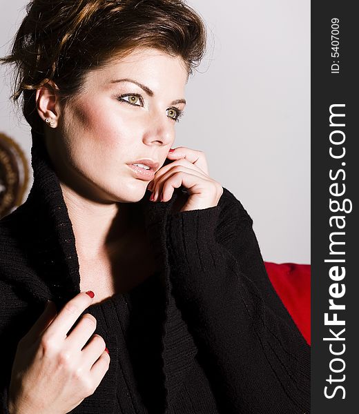 Close-up of a beautiful young woman wearing a black sweater. Close-up of a beautiful young woman wearing a black sweater