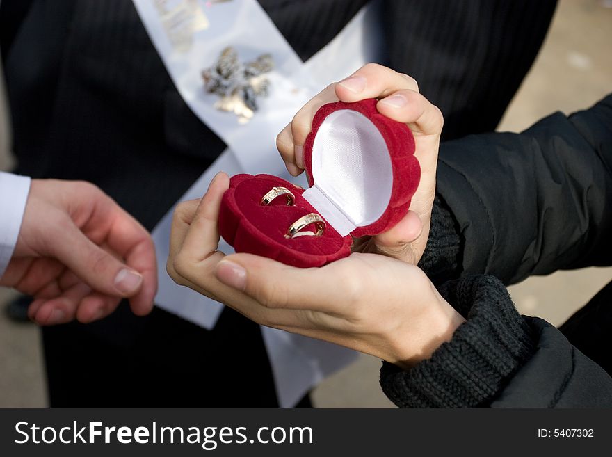 Man holds in hands a box with golden rings. Man holds in hands a box with golden rings