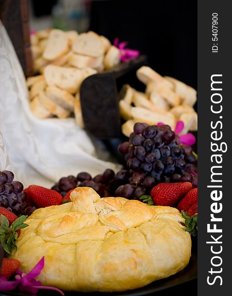 An appetizer selection of cheese, crackers, grapes and strawberries. An appetizer selection of cheese, crackers, grapes and strawberries