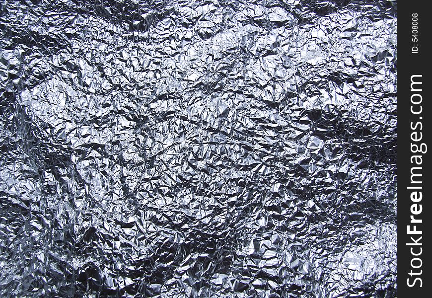 Crumpled tin foil laid flat to make almost landscape type surface.