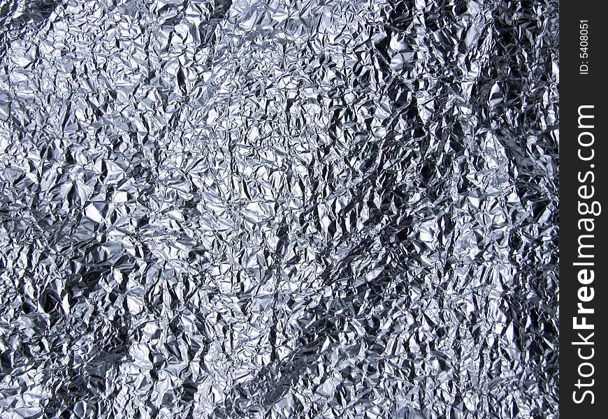 Crumpled tin foil laid flat to make almost landscape type surface.