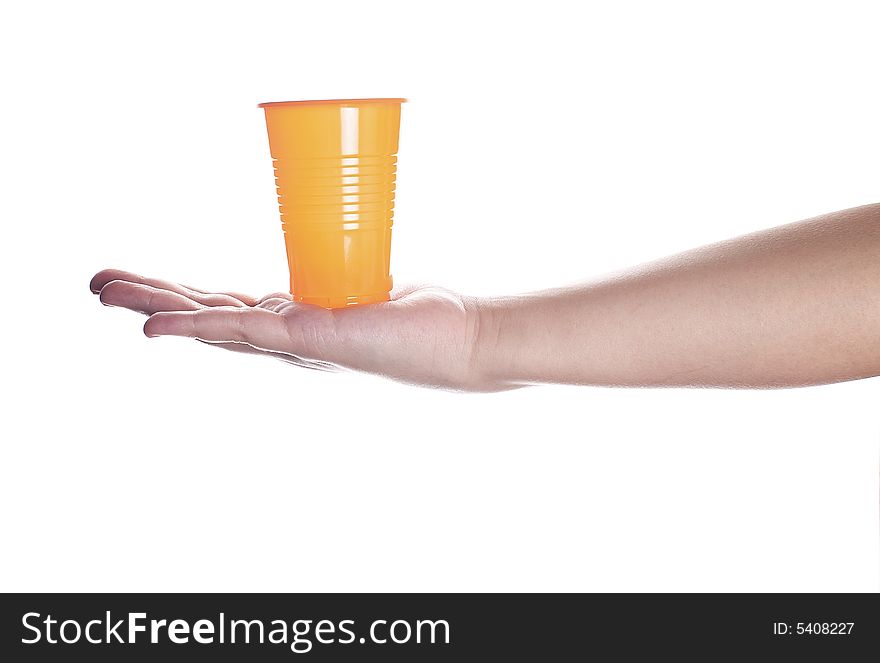 Orange plastic cup in female hand isolated on white.