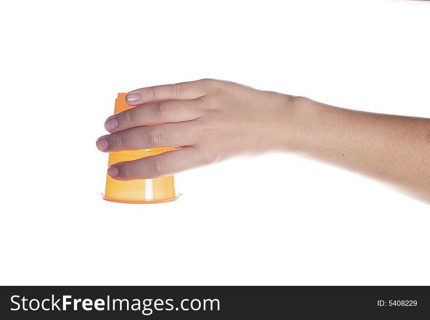 Orange plastic cup in female hand isolated on white. Orange plastic cup in female hand isolated on white.