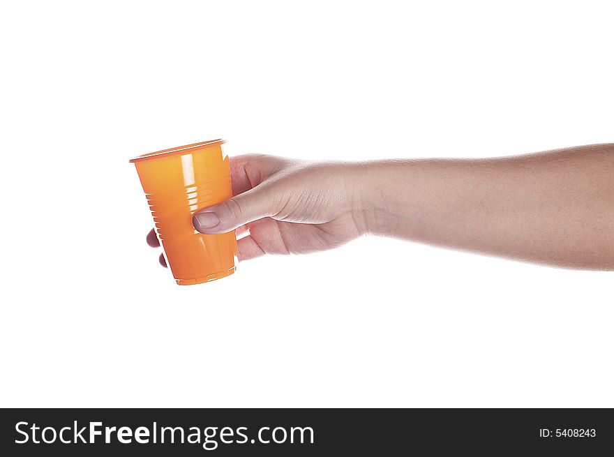 Orange plastic cup in female hand isolated on white. Orange plastic cup in female hand isolated on white.