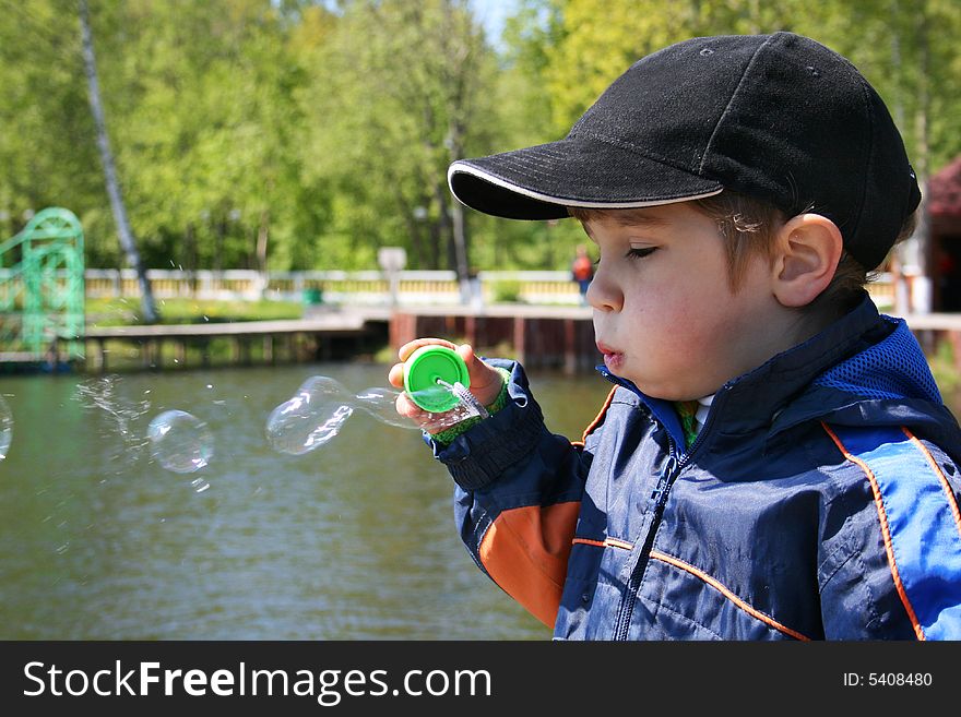 4-year old kid plays with soap bubble. 4-year old kid plays with soap bubble