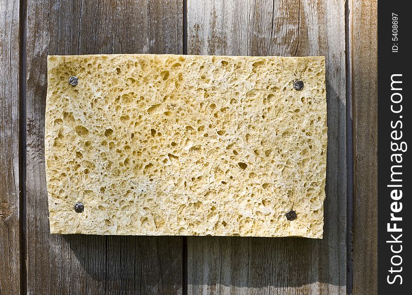 Old Sponge On Wooden Background