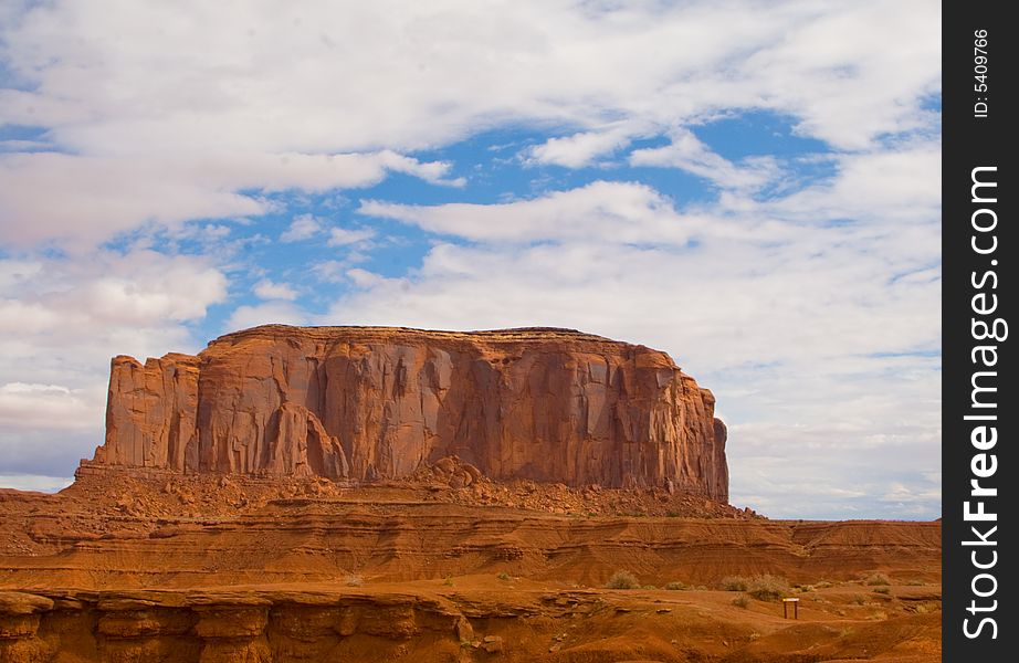 Solitary Butte in Monument Valley under cloudy sky