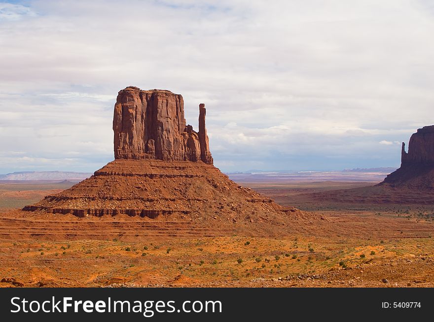 East and West Mitten Buttes in Monument Valley under cloudy sky