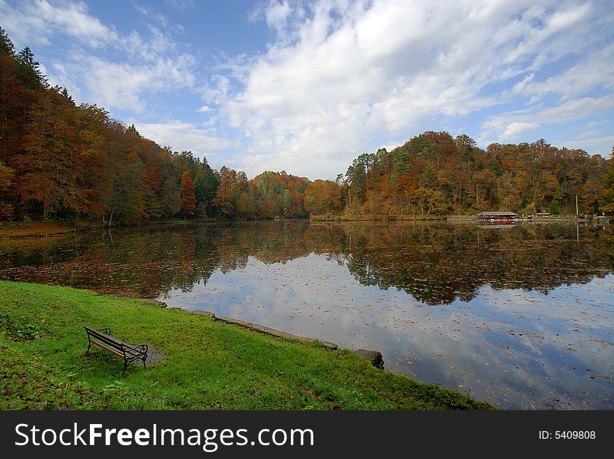 A bench near lake taken in fall.