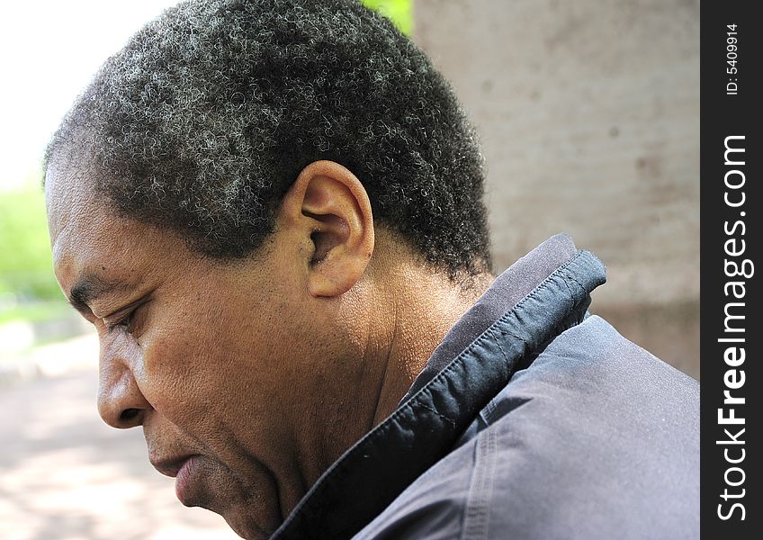 Portrait of a african american male sitting in a park.