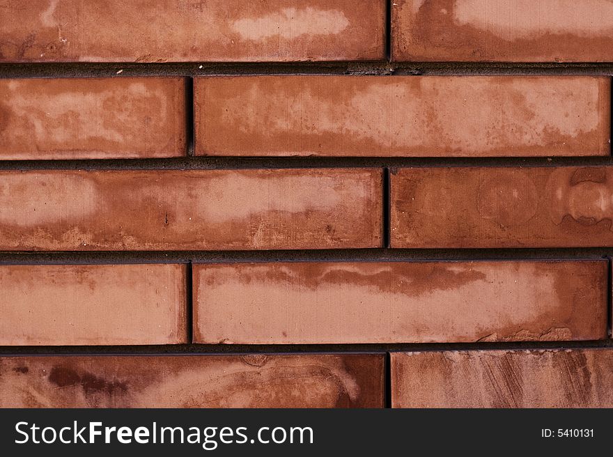 A worn red brick wall texture, or background. A worn red brick wall texture, or background.