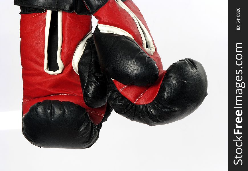 Boxing gloves with a white background hanging up. Boxing gloves with a white background hanging up