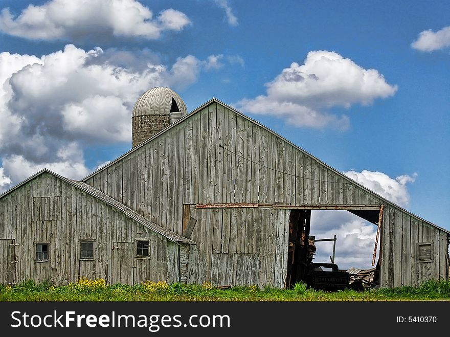 Old bleached out barn against a morning sky. Old bleached out barn against a morning sky.