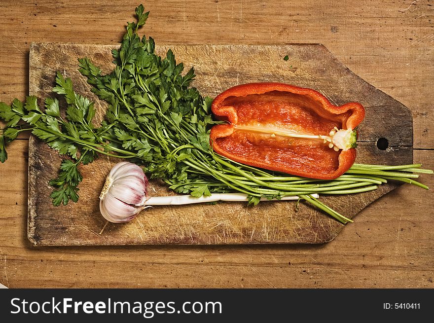 Pepper, garlic and parsley on wooden table. Pepper, garlic and parsley on wooden table.