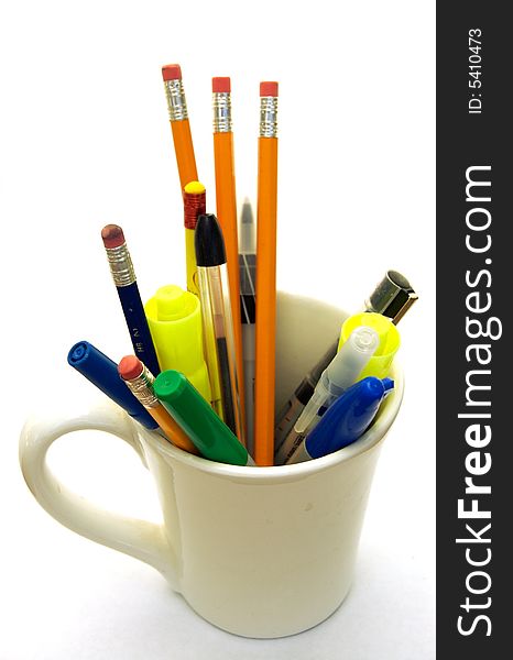 A photograph of pens and pencils in a cup