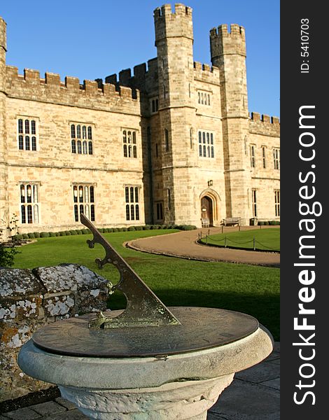 Old concrete sundial with castle background. Old concrete sundial with castle background
