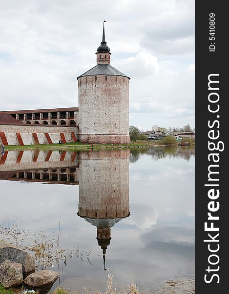 The Tower Of A Monastery Is Reflected In Water