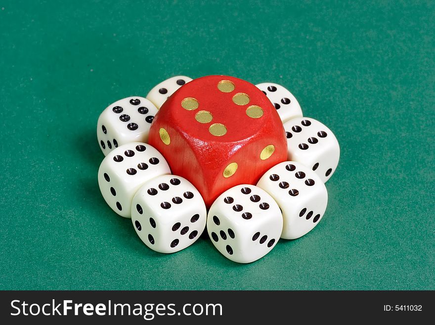 White and red dice on green background