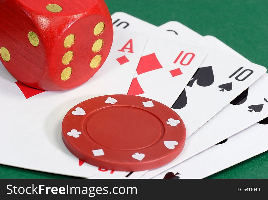 Red Dice with playing cards on green background. Red Dice with playing cards on green background