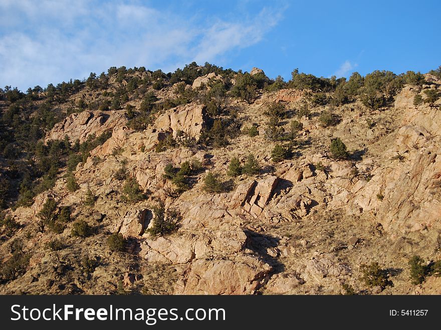 A rocky hill top in Colorado with bright blue sky background