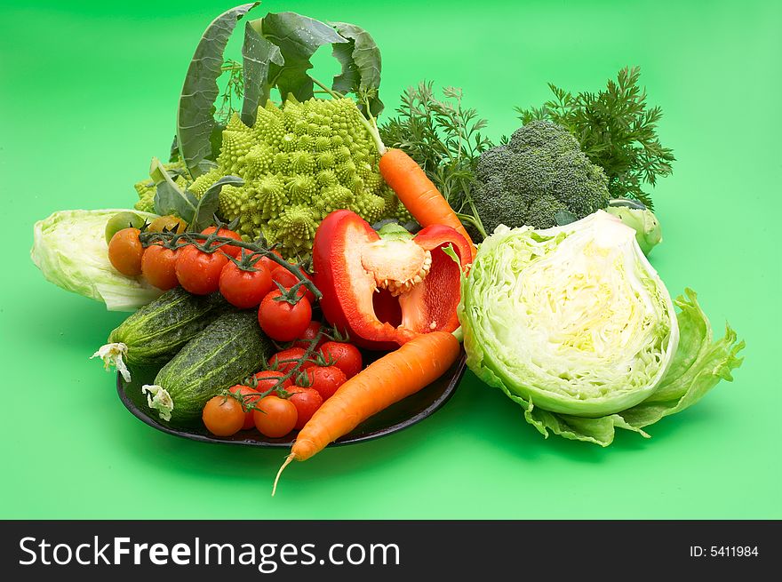 Set of healthy fresh vegetables on green background