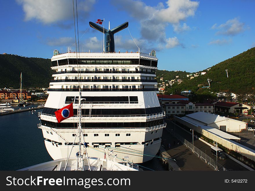 Giant cruise liners filled with sunset light anchored in a port on St.Thomas island, U.S. Virgin Islands. Giant cruise liners filled with sunset light anchored in a port on St.Thomas island, U.S. Virgin Islands.