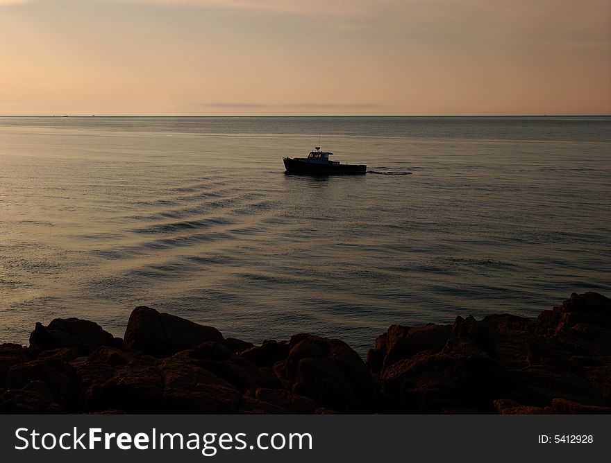 Lobster boat heading out at sunrise