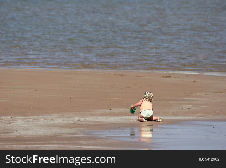 child plays on a beach