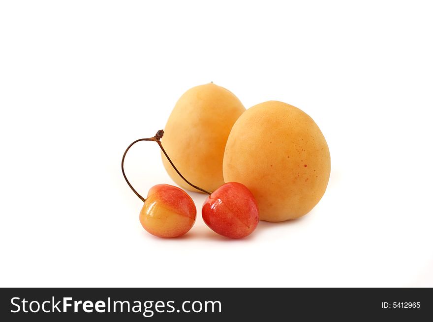 Apricot and sweet cherry on a white background