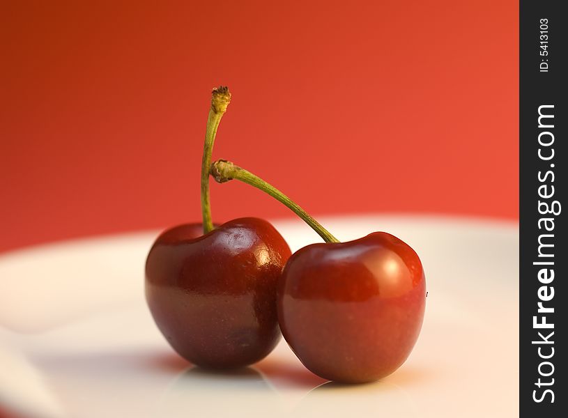 Two cherries on white plate. Two cherries on white plate.