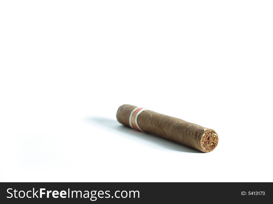 A Cuban cigar isolated on a white background. A Cuban cigar isolated on a white background.