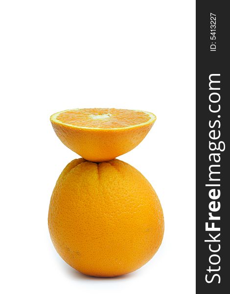 Orange section balancing on a whole orange. Orange section balancing on a whole orange