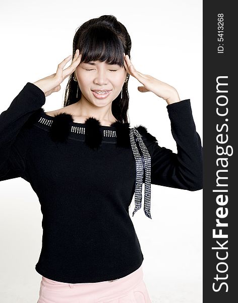 Asian woman with headache against white background