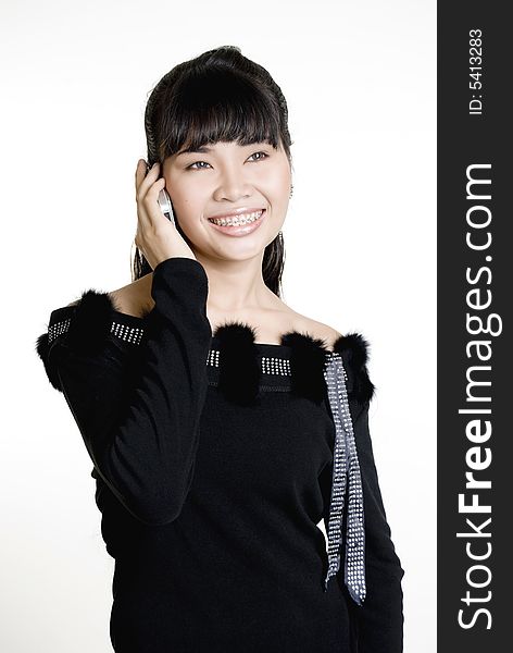 Asian woman on phone, against white background. Asian woman on phone, against white background