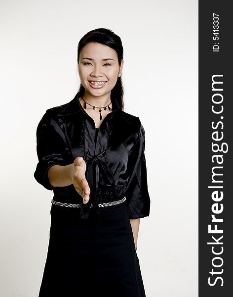 Asian woman shakes hands, against white background. Asian woman shakes hands, against white background