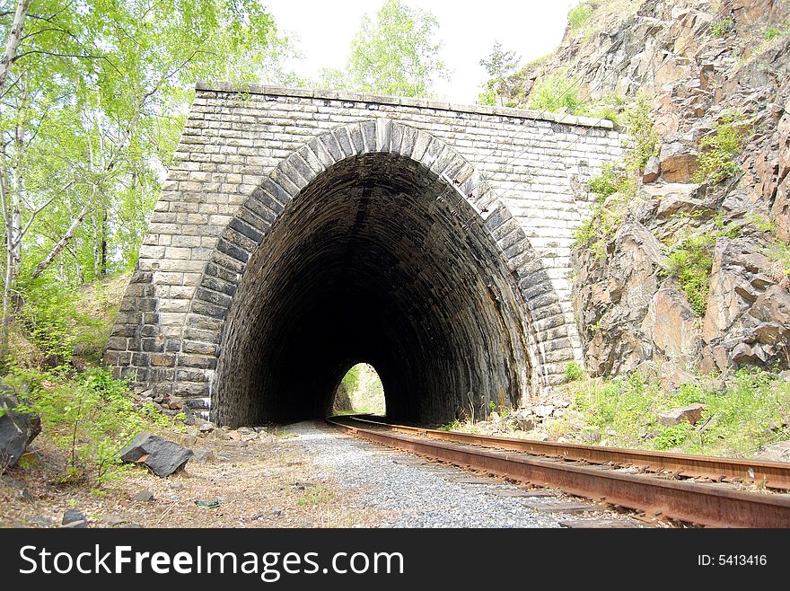 Abandoned stone tunnel over the old railroad around Bailal lake