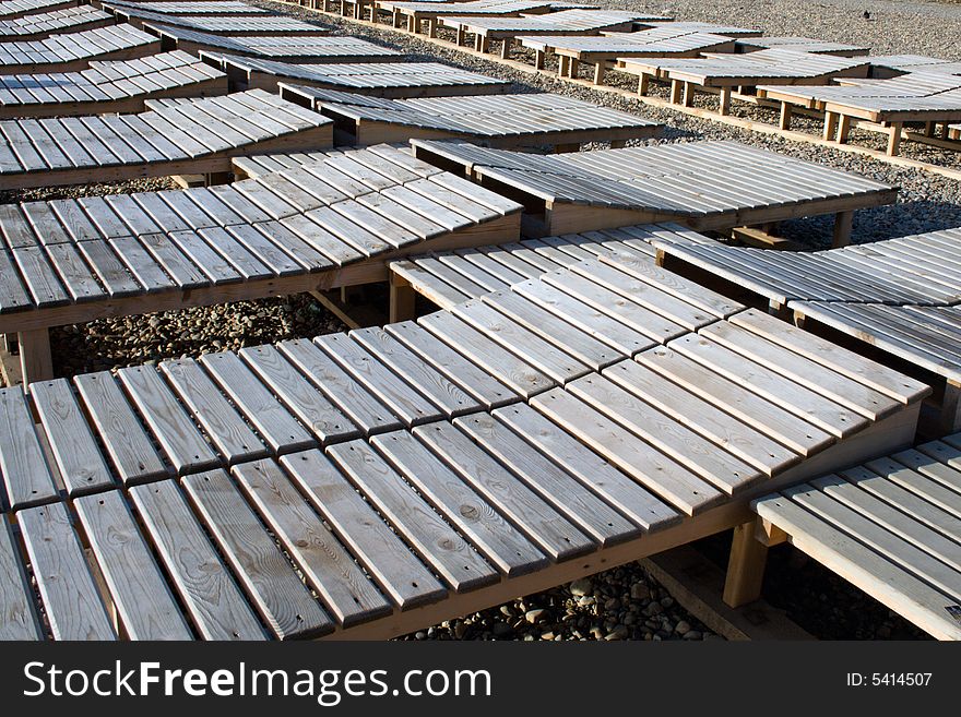 Empty plank beds on a beach