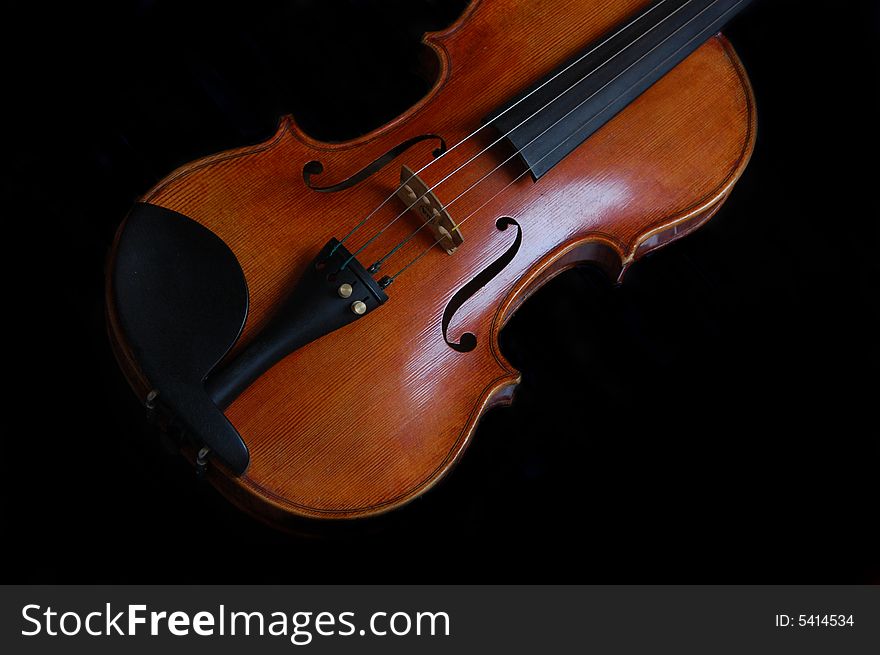 A violin against black backdrop