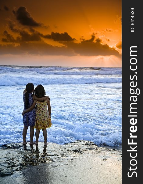 Two girls in the beach at sunset. Two girls in the beach at sunset