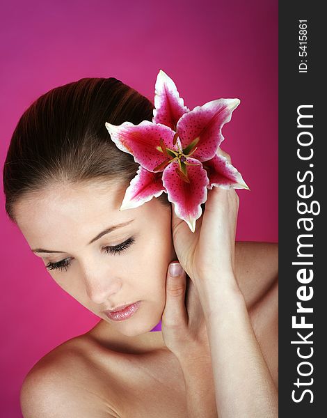 Beauty portrait of a young woman with a ribbon and a flower. Beauty portrait of a young woman with a ribbon and a flower