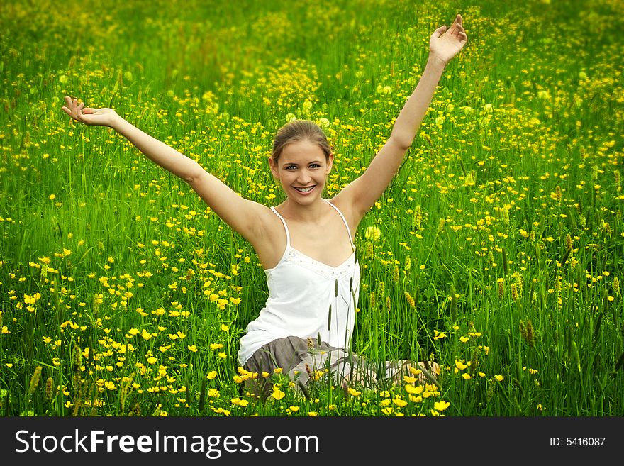 Happy woman on a meadow in front of the blue sky. Happy woman on a meadow in front of the blue sky