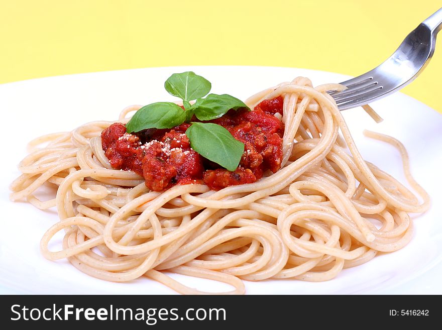 Spaghetti bolognese served on white plate