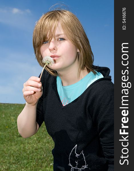 The young girl with a dandelion